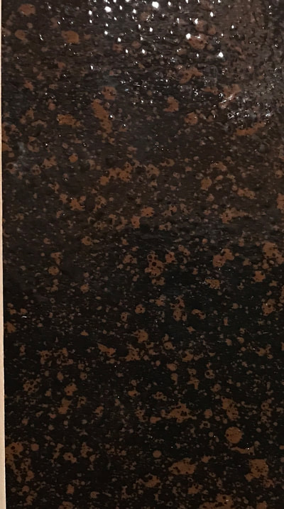 Image of our Lava Rock design for countertop refinishing. You can see a dark brown background with lighter brown spots. 