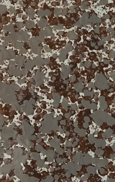 Image of the Mexican Sand Countertop surface finish. You can see gray with red blending together. 