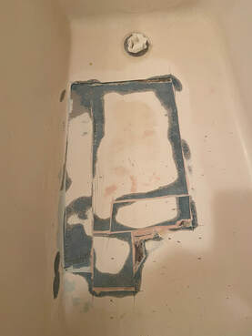 Picture of a bathtub that is being resurfaced. Different layers of bathtub finishes are being  applied. 