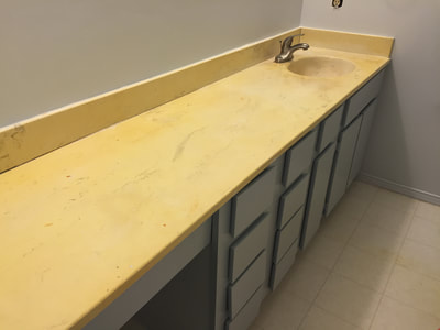 Before picture of a outdated wooden bathroom vanity. 