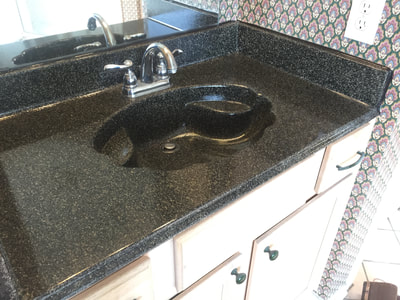 Picture of a bathroom vanity countertop and sink refinished. 