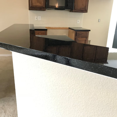 Image of sable stone on kitchen counter resurface. you can see the refinished Tile with black and white color. 