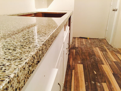 Picture of a kitchen countertop that has a shiny look to it. 