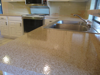 In this image you can see a close up of a kitchen countertop that has recently been resurfaced with the Lucid Pebble color. 