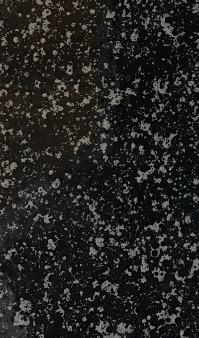 This image shows our Sable Stone color pattern for countertops. You can see a black background with gray and white specks. 