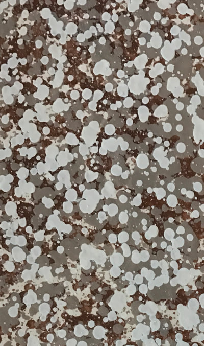Image of the Large Sedona countertop finish. You cans see a gray background with white and red spots.