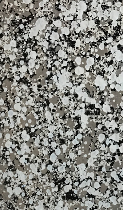 Image of our Graphite color pattern for countertop refinishing. You can see a gray and white background with black blotches mixed in. 