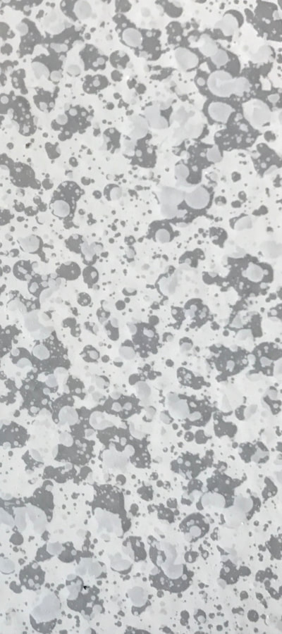 Image of a Gay Marble countertop surface. You can see black and gray blotches on a white background. Imitating a marble countertop 