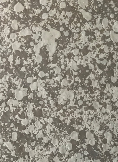 In this image you can see the Large Lucid Pebble Countertop resurfacing color pattern. You can see a dull brown background with large white pebble spots.