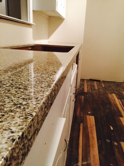 This is a picture of a newly resurfaced kitchen countertop. You can see a close up the Graphite color pattern. 