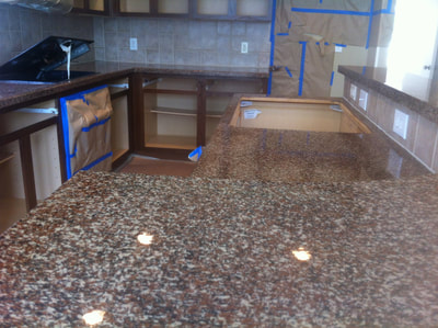 This picture shows a Kitchen countertop transformation using the Bronze Gravel color option. You can see the entire kitchen in the process of a countertop resurfacing. 