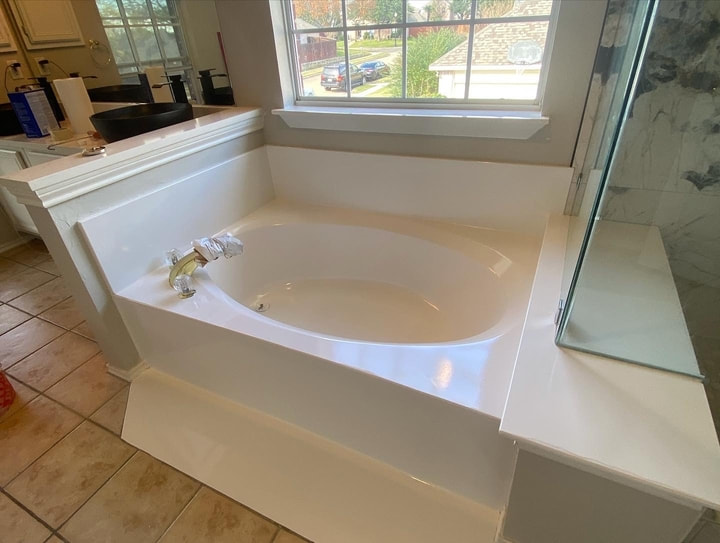 Picture of a bathtub that has just been refinished. The only thing that is left to do is to take of the protection over the knob.  