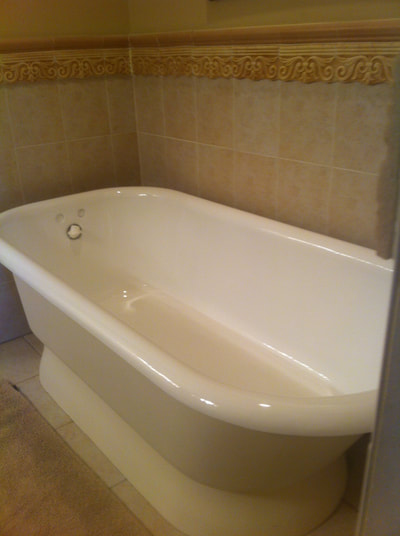 Picture of a bathtub that looks shiny and new, It just got refinished. 