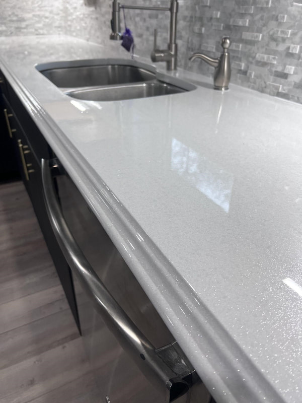 Image of a resurfaced countertop. You can see a shinny white countertop surface 