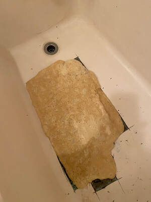 Picture of bathtub that is being refaced. The parts that were worn out are already removed and now you can see that a foam is being applied. 