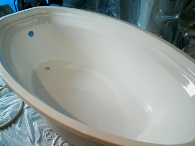 Picture of a jetted tub in the process of refinishing.