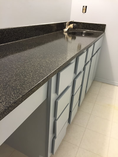 Image of Sable stone on kitchen countertop resurface. you can see the refinished Tile with black and white color. 