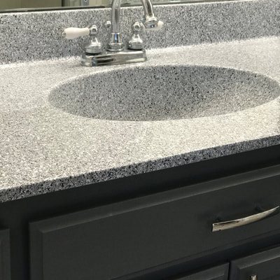 Image of Grey Marble counter resurfacing. you can see the refinished Tile with dark grey and white color. 