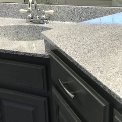Image of Grey Marble on kitchen countertop resurface. you can see the refinished Tile with grey and white color. 