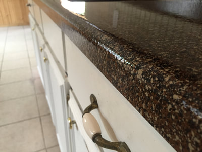 Closeup picture of a refinished countertop. You can clearly see the type of finish they used, lava rock. 