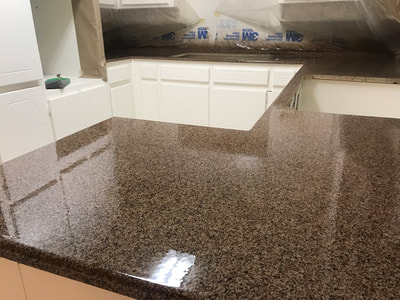 Picture of a kitchen countertop resurfacing project using the Bronze Gravel color pattern. You can see a close up of the the countertop with a white background. 
