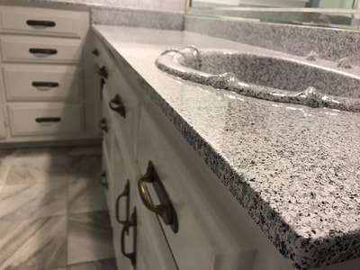 Image of a bathroom countertop resurfacing job. You can see a refinished sink and bathroom countertop using the Grey Marble colo.