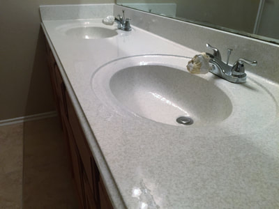 Picture of a bathroom countertop that has a new look to it. You can see the shiny countertop. 