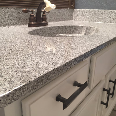 Image of Grey Marble on refinishing kitchen countertop. you can see the refinished Tile with Grey and white color. 