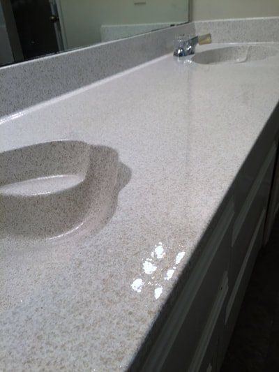 Image of Moon Rock on kitchen countertop resurface. you can see the refinished Tile with shining white color. 