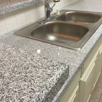 Image of Grey Marble on kitchen resurface. you can see the refinished Tile with grey and white color. 