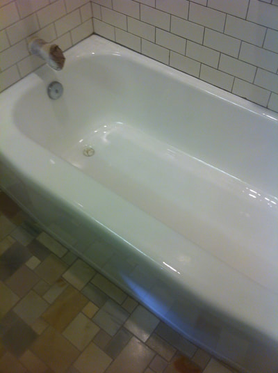 In this image you can see the refinished bathtub. you can see a clear white bathtub with a tile background. 