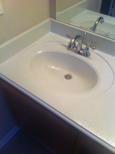 Picture of a refinished  bathroom countertop. You can see a White Dust surface color on the bathroom countertop and sink.