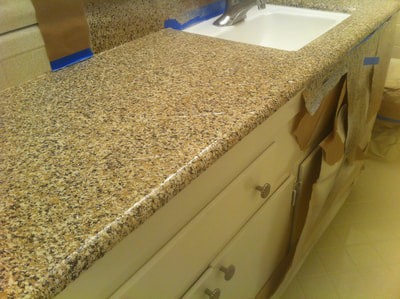 Picture of Graphite countertop resurfacing. You can see the resurfacing of a vinyl countertop.