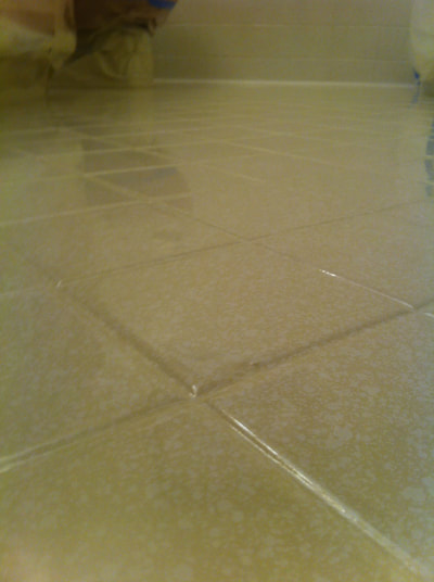 picture of lucid pebble color pattern on tile. You can see newly refinished shower tile with yellow and white.