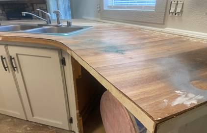 Picture of kitchen countertop. You can see the a wooden texture kitchen countertop.