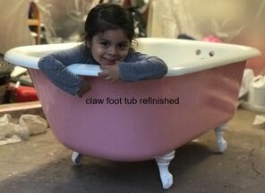 Picture of a bathtub resurfacing job in dallas. You can see a Pink claw foot bathtub with a small child  sitting in the tub smiling  at the camera. 
