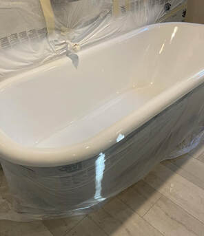 Picture of a bathtub in the process of refinishing. The total time of the refinishing project will be under a day. 