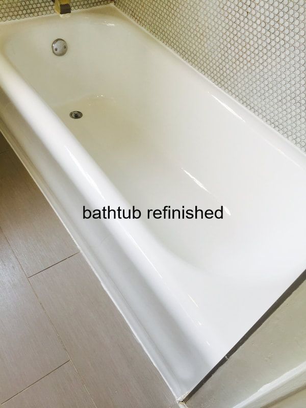 this image shows a bathtub that has been fully resurfaced in dallas. You can see a white bathtub with and grey tile.