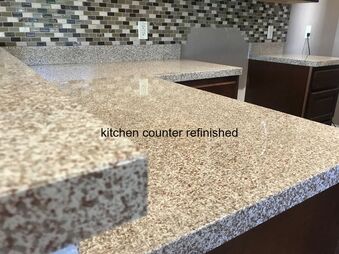 This image shows kitchen countertop that has been refinished. You can see brown and white spot pattern countertop with dark brown cabinets 