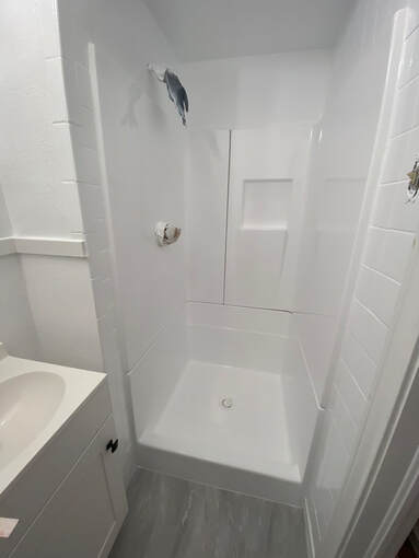 Picture of a modern looking, refinished shower. You can see that any imperfections and cracks are now repaired and sealed up. 