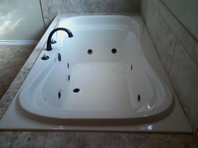 Picture of a jacuzzi that is shiny bright and white and clean after it got refinished. 